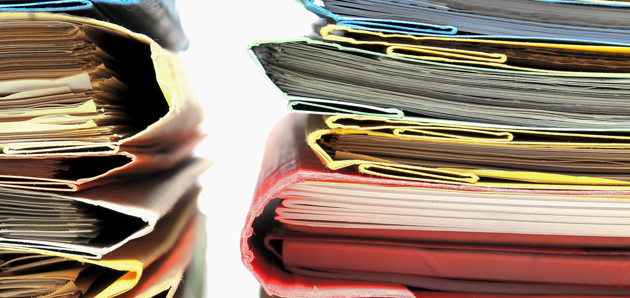 Two stacks of colourful folders.